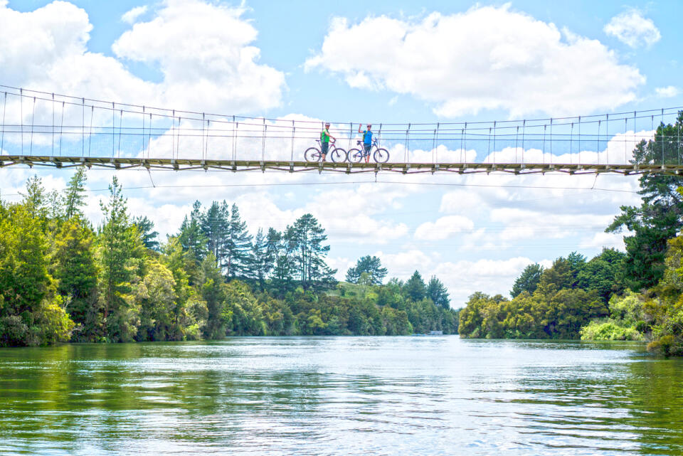 Waikato River Trails Two cyclists on suspension bridge credit Waikato River Trails